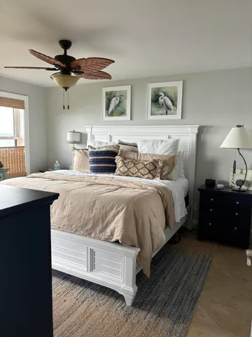 a bedroom with a bed and ceiling fan