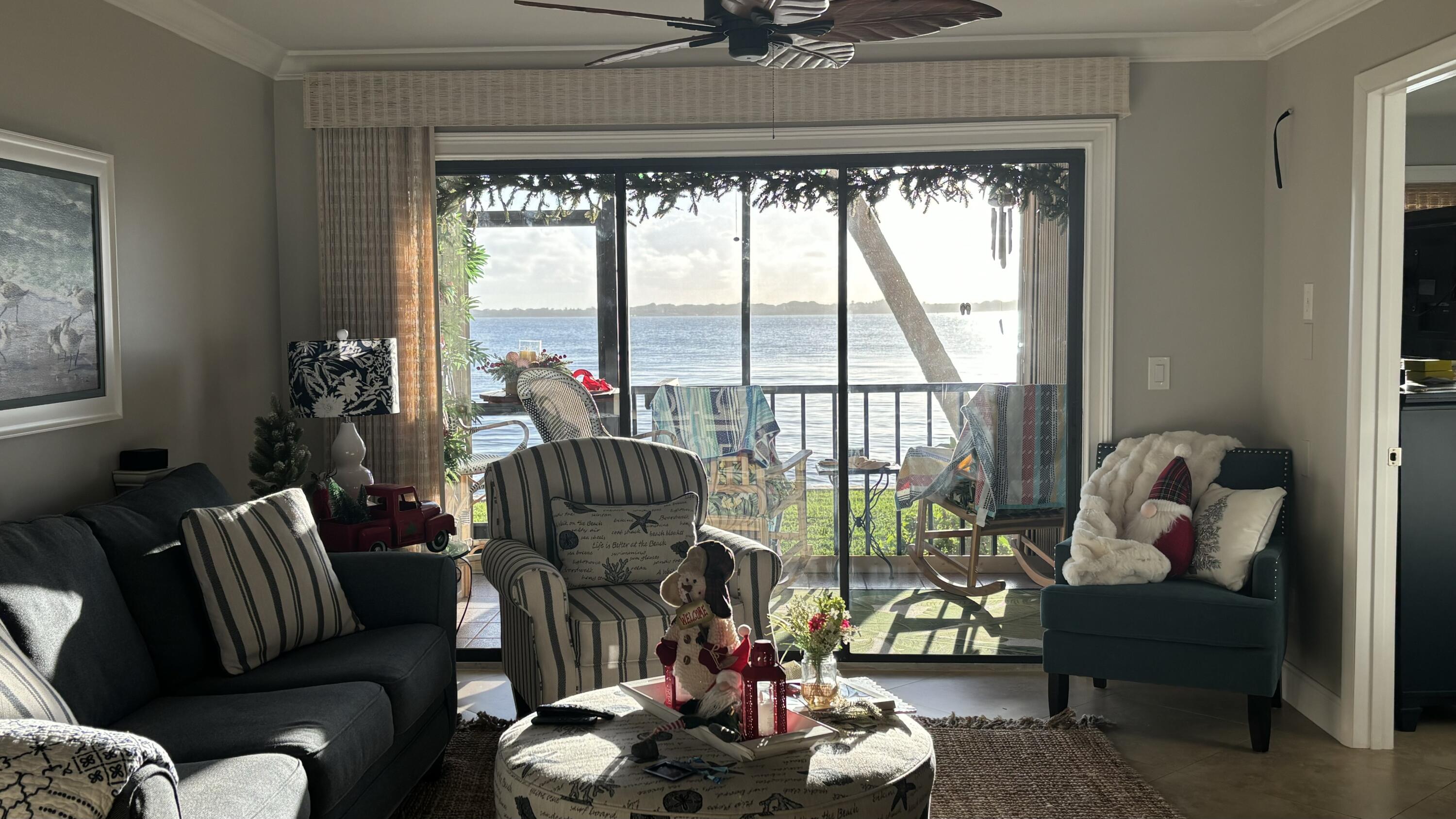 4440 Northeast Sandpebble Trace, Unit 104 Stuart, FL 34996 - Photo 31 of 33 a living room with furniture and a large window