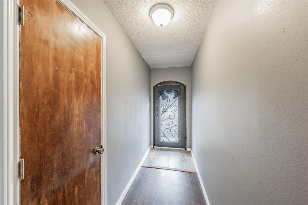 245 Gordon Drive Azle, TX 76020 - Photo 14 of 38 a view of a hallway with wooden floor