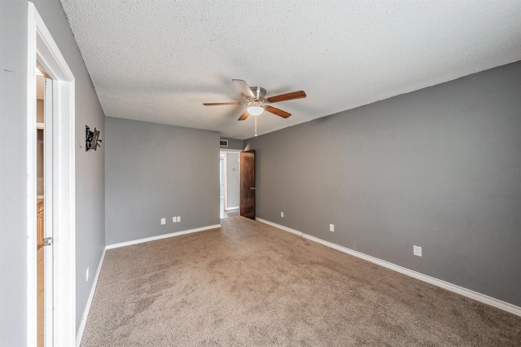 245 Gordon Drive Azle, TX 76020 - Photo 18 of 38 a view of an empty room with a ceiling fan