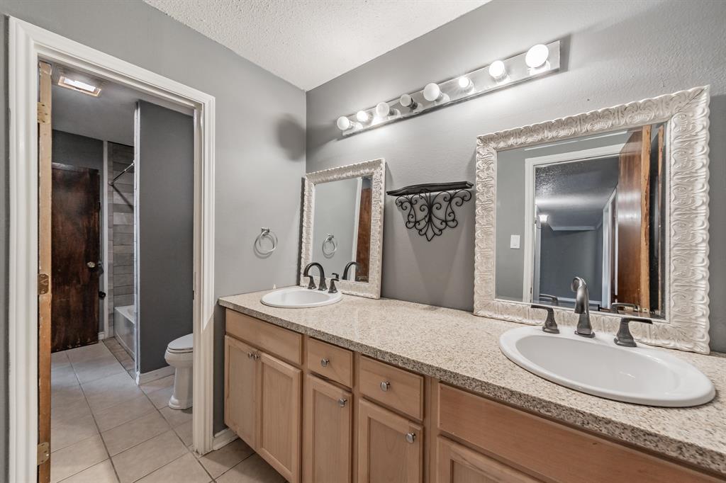 245 Gordon Drive Azle, TX 76020 - Photo 19 of 38 a bathroom with a double vanity sink and a mirror