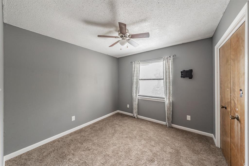 245 Gordon Drive Azle, TX 76020 - Photo 23 of 38 an empty room with closet and windows