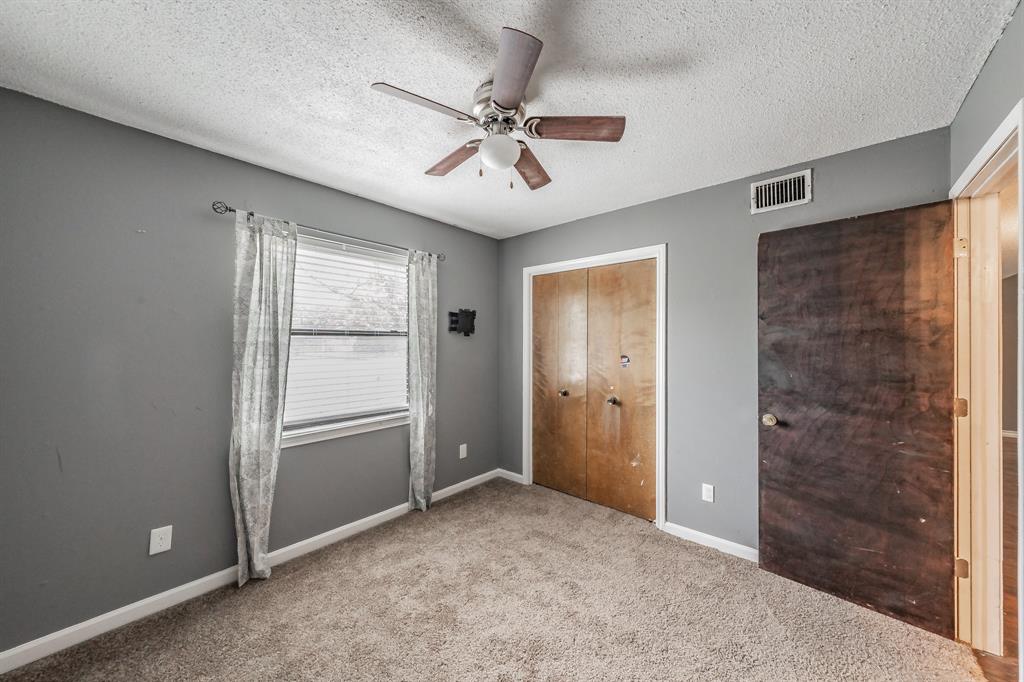 245 Gordon Drive Azle, TX 76020 - Photo 24 of 38 an empty room with fan and windows
