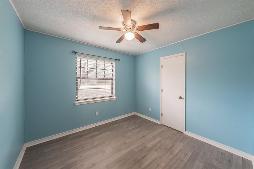 245 Gordon Drive Azle, TX 76020 - Photo 25 of 38 wooden floor in an empty room with a window