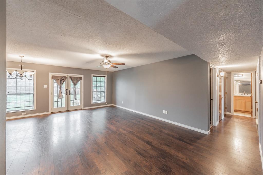 245 Gordon Drive Azle, TX 76020 - Photo 3 of 38 a view of an empty room with wooden floor and a window