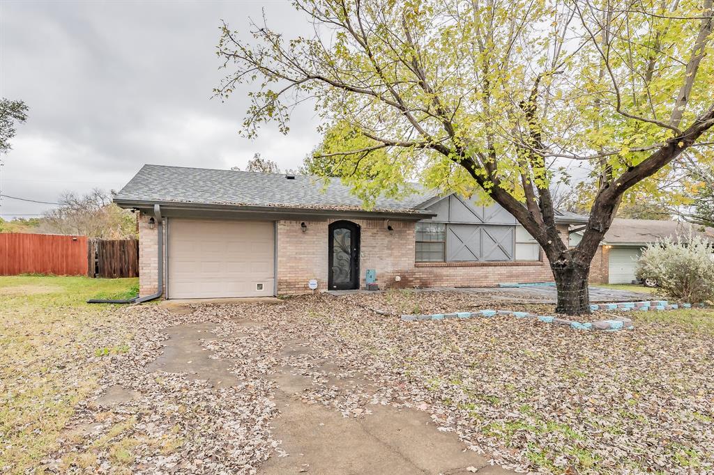 245 Gordon Drive Azle, TX 76020 - Photo 36 of 38 a front view of a house with a yard and garage