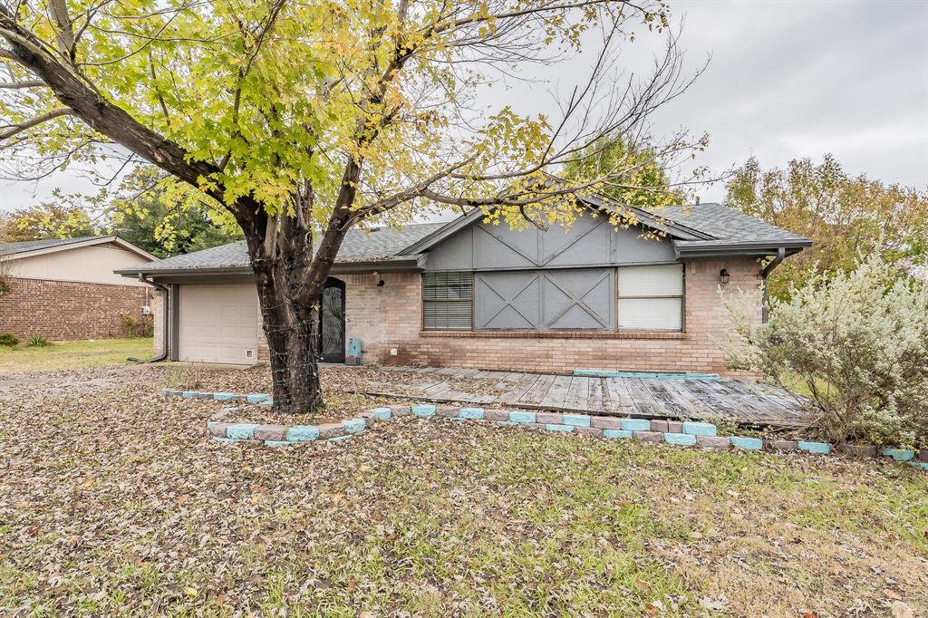 245 Gordon Drive Azle, TX 76020 - Photo 37 of 38 a front view of a house with a yard