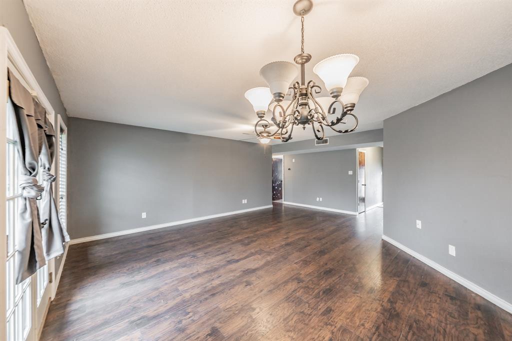 245 Gordon Drive Azle, TX 76020 - Photo 5 of 38 a view of a chandelier in big room with wooden floor