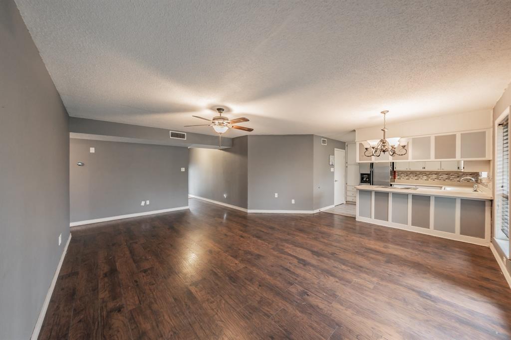 245 Gordon Drive Azle, TX 76020 - Photo 6 of 38 a view of a livingroom with a furniture wooden floor and chandelier