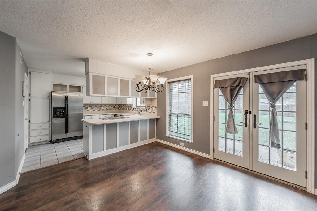 245 Gordon Drive Azle, TX 76020 - Photo 8 of 38 a large kitchen with stainless steel appliances granite countertop a stove and a refrigerator