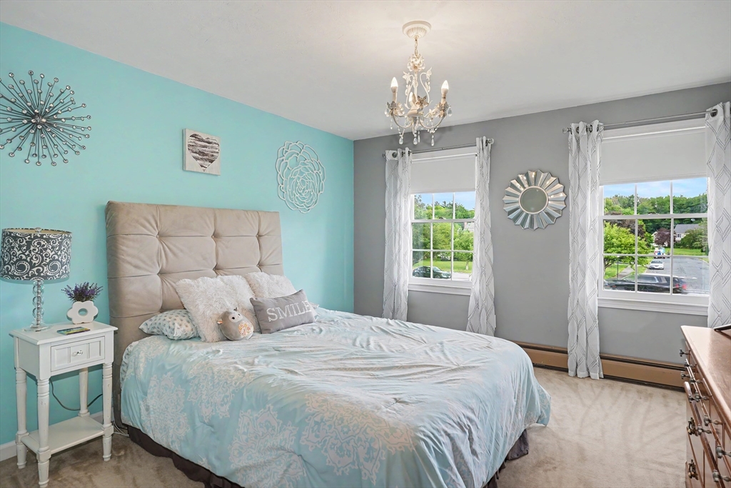 15 Lanthorn Road Northborough, MA 01532 - Photo 25 of 37 a bedroom with a large bed and a chandelier