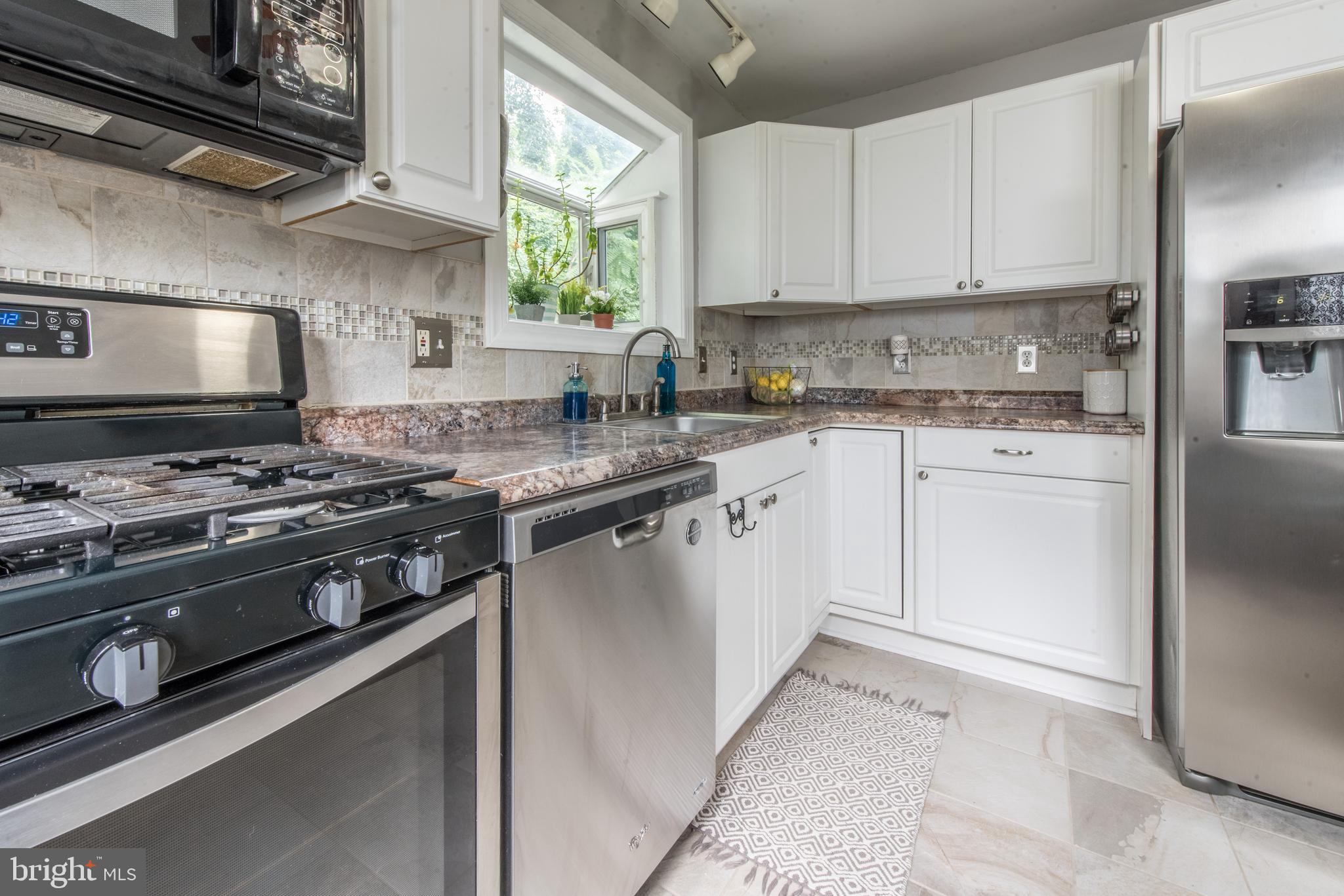 1346 Sudvale Road Baltimore, MD 21208 - Photo 12 of 30 a kitchen with stainless steel appliances granite countertop a stove and a sink