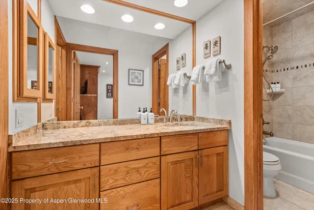 a bathroom with a granite countertop sink mirror and a