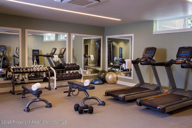 a room with gym equipment and a large window