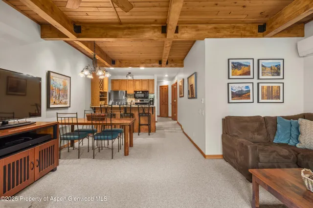a dining room with furniture and a flat screen tv