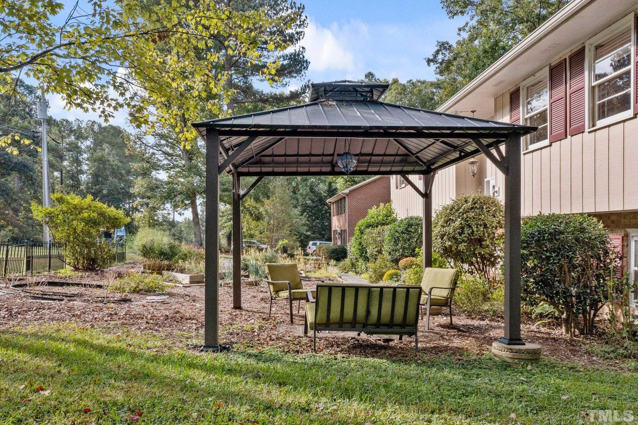 5101 Raintree Road Durham, NC 27712 - Photo 4 of 30 a view of a deck with a table and chairs under an umbrella