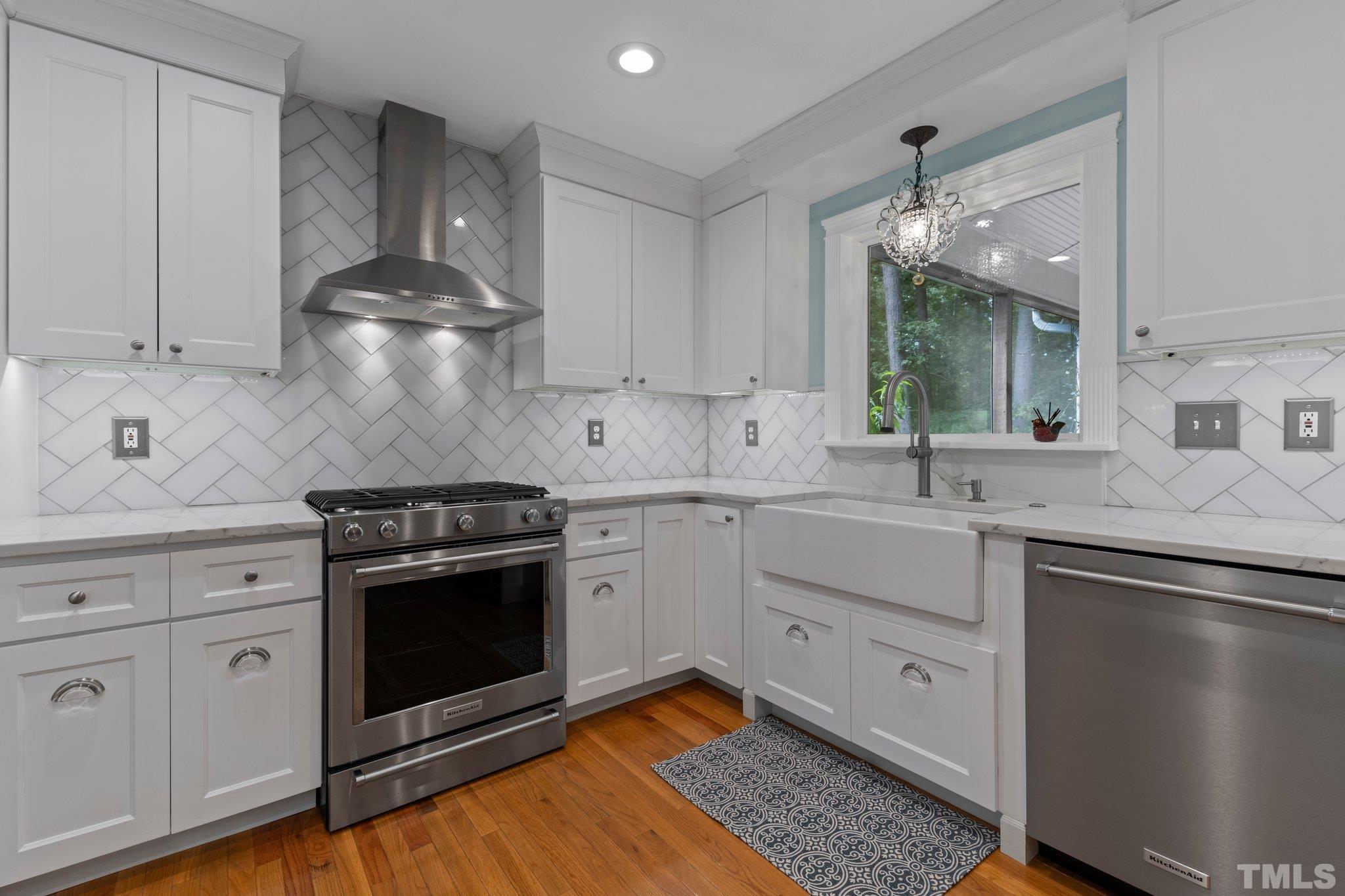 5101 Raintree Road Durham, NC 27712 - Photo 7 of 30 a kitchen with white cabinets stainless steel appliances and sink