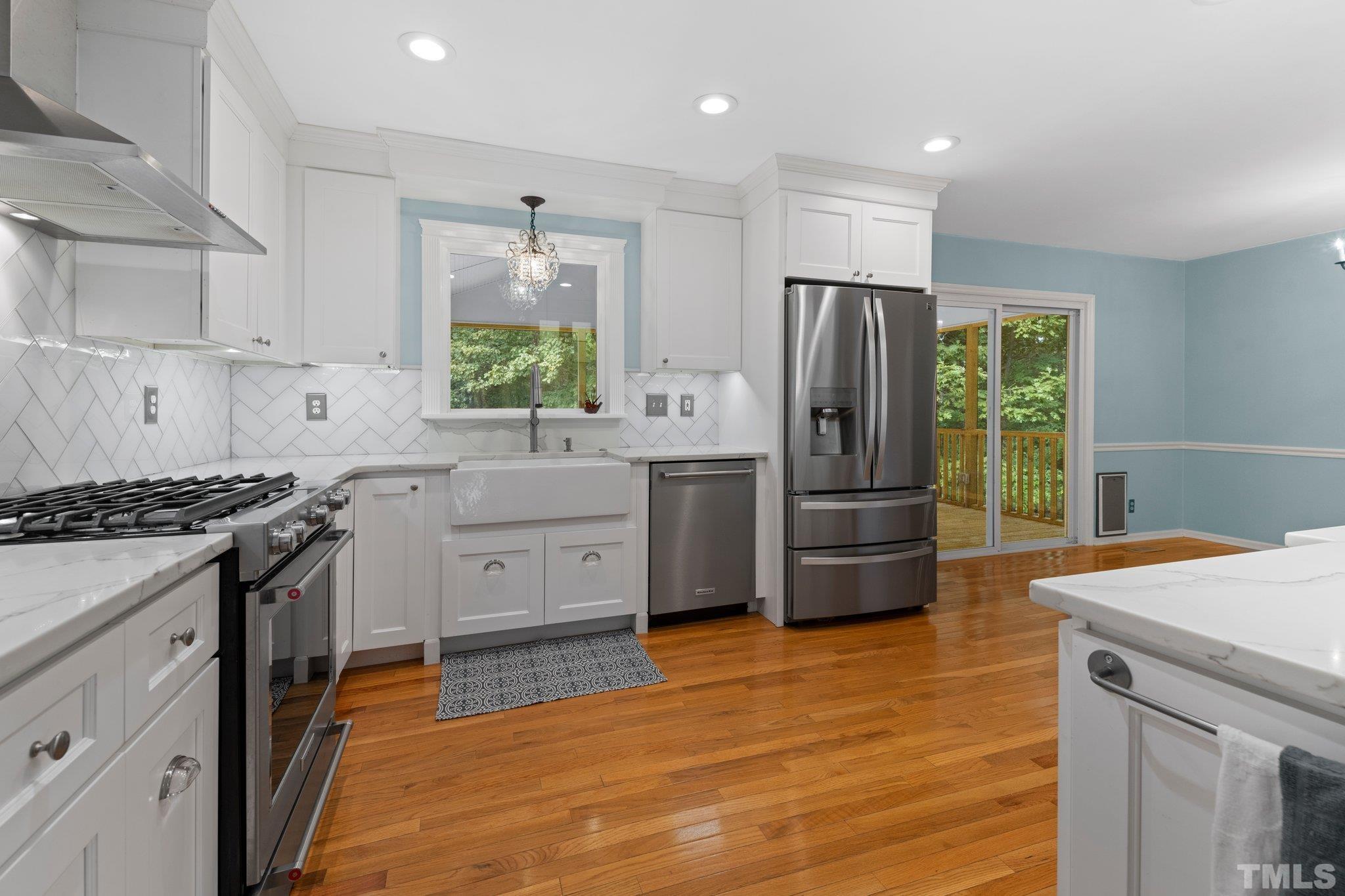 5101 Raintree Road Durham, NC 27712 - Photo 10 of 30 a kitchen with stainless steel appliances granite countertop a stove refrigerator and microwave
