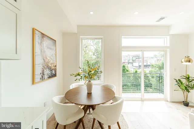 a dining room with furniture and window