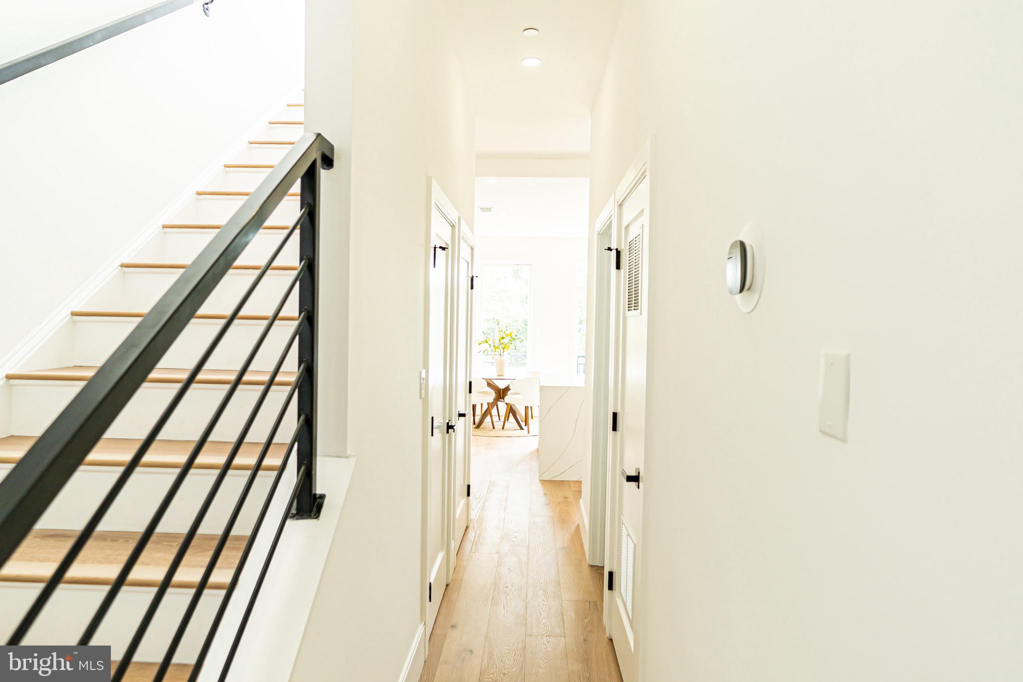 2517 Ontario Road Northwest, Unit PH8 Washington, DC 20009 - Photo 19 of 41 a view of a hallway with wooden floor and staircase