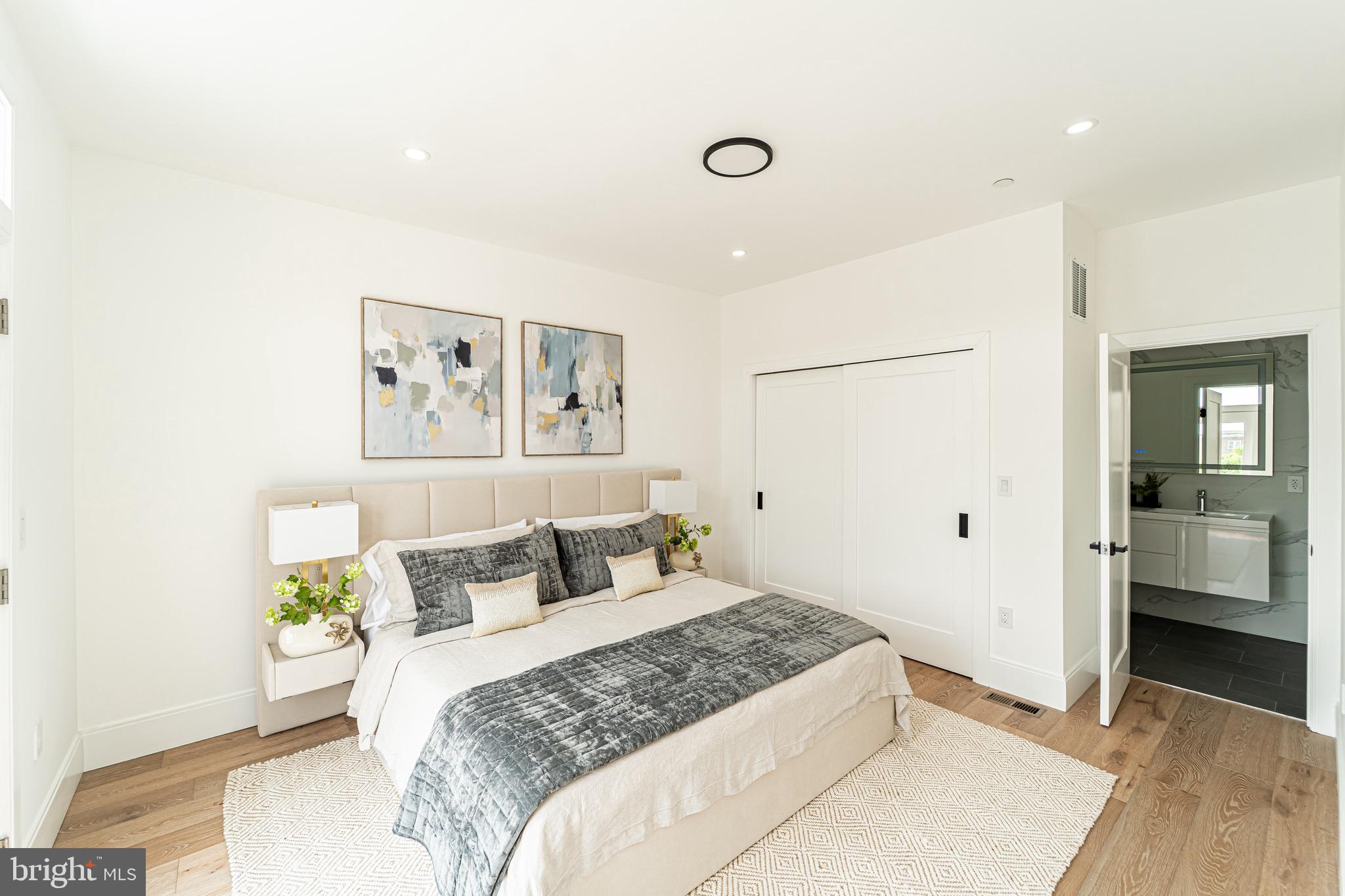 2517 Ontario Road Northwest, Unit PH8 Washington, DC 20009 - Photo 20 of 41 a bedroom with a large bed and a chandelier