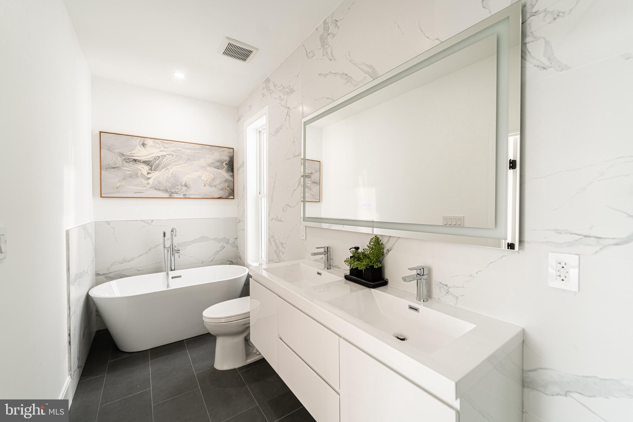 2517 Ontario Road Northwest, Unit PH8 Washington, DC 20009 - Photo 25 of 41 a bathroom with a toilet sink and mirror