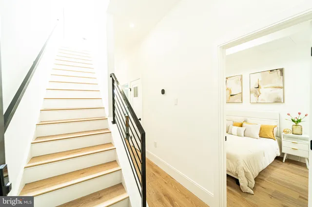 a bedroom with a bed and a painting on the wall