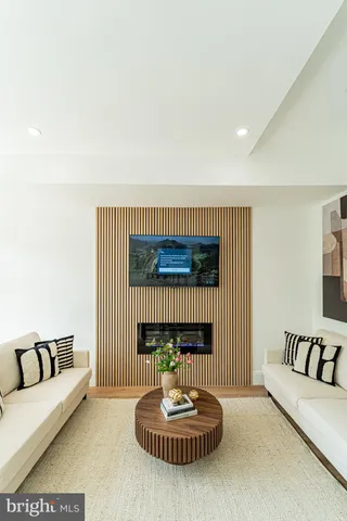 a living room with furniture a window and a fireplace