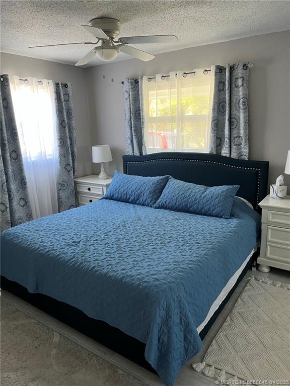 2340 Northeast Rustic Way Jensen Beach, FL 34957 - Photo 12 of 19 a bedroom with a bed and window
