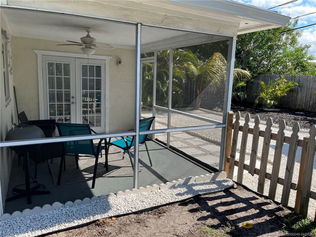 2340 Northeast Rustic Way Jensen Beach, FL 34957 - Photo 14 of 19 a building outdoor space with patio furniture and potted plants