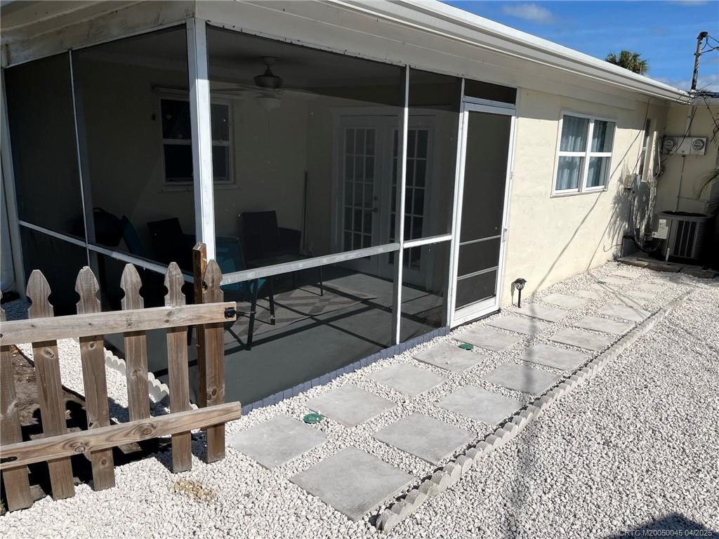 2340 Northeast Rustic Way Jensen Beach, FL 34957 - Photo 15 of 19 a view of house with wooden floor and windows
