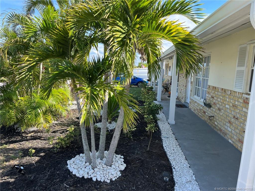 2340 Northeast Rustic Way Jensen Beach, FL 34957 - Photo 18 of 19 a view of a potted plants with palm trees