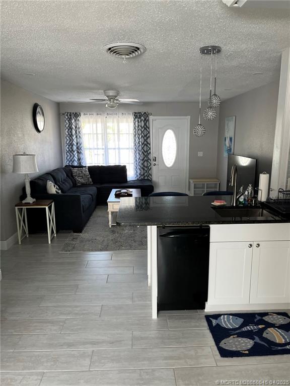 2340 Northeast Rustic Way Jensen Beach, FL 34957 - Photo 3 of 19 a living room with kitchen island granite countertop furniture and a fireplace