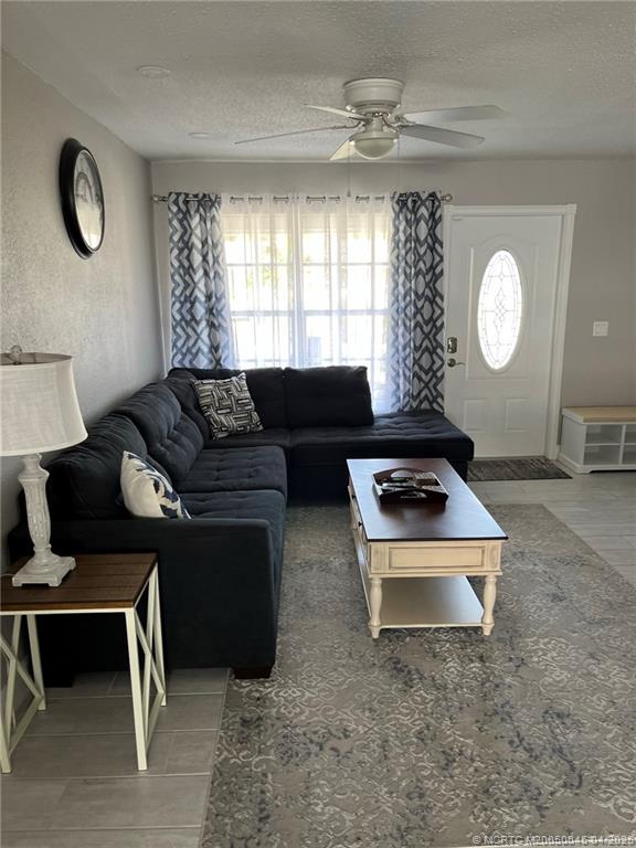 2340 Northeast Rustic Way Jensen Beach, FL 34957 - Photo 4 of 19 a living room with furniture rug and window