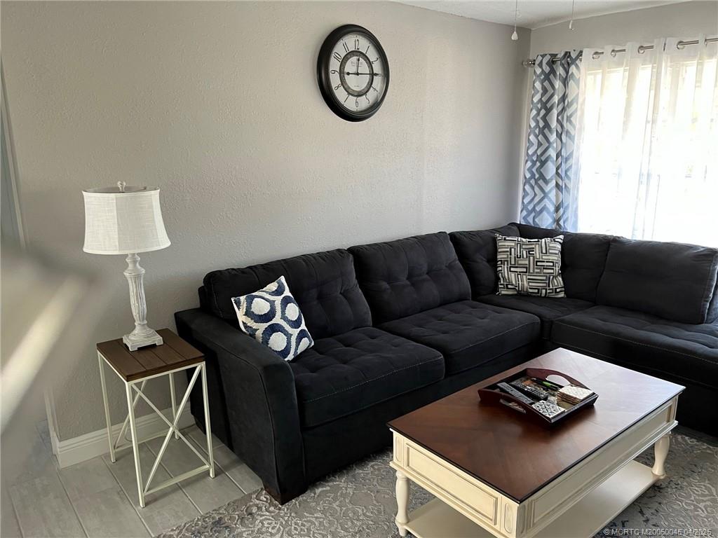 2340 Northeast Rustic Way Jensen Beach, FL 34957 - Photo 5 of 19 a living room with furniture and a window