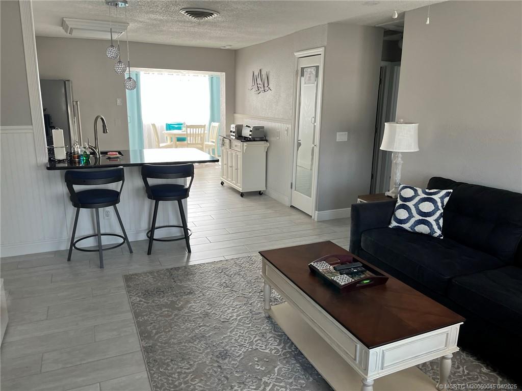 2340 Northeast Rustic Way Jensen Beach, FL 34957 - Photo 6 of 19 a living room with furniture and a window
