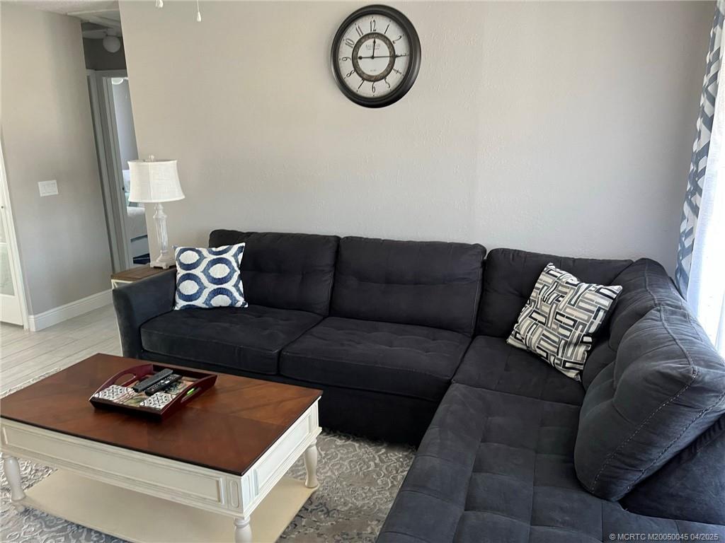 2340 Northeast Rustic Way Jensen Beach, FL 34957 - Photo 7 of 19 a living room with furniture and a table