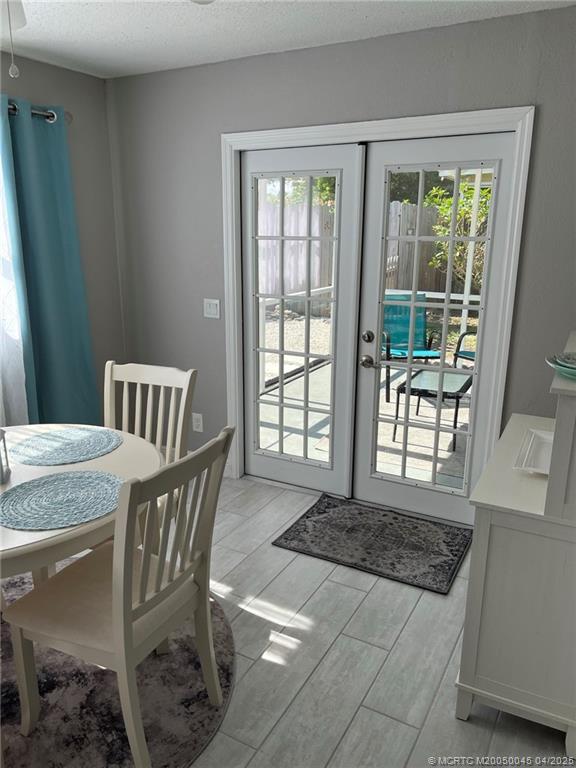 2340 Northeast Rustic Way Jensen Beach, FL 34957 - Photo 10 of 19 a view of a dining room with furniture window and outside view