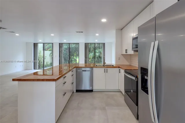 a kitchen with a sink stove and refrigerator