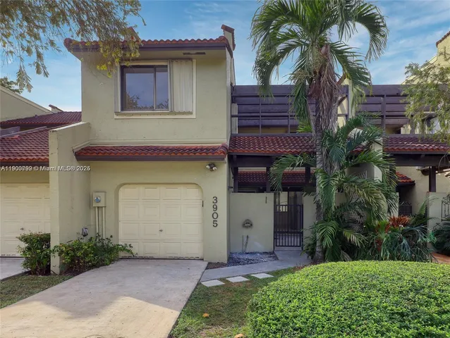 a front view of a house with a garden and a yard