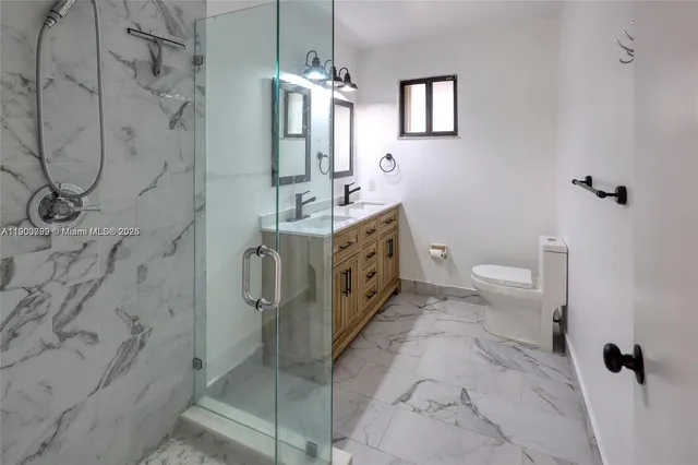 a spacious bathroom with a granite countertop sink a toilet and shower