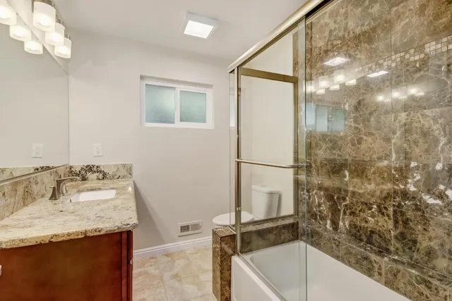 a view of a patio with table and chairs under an umbrella
