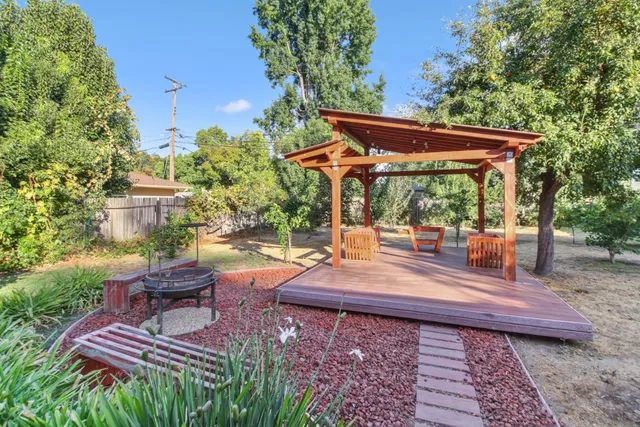a front view of a house with a yard and potted plants