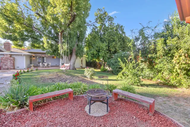 an aerial view of a house with garden space and street view