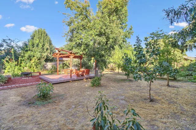 an aerial view of a houses with a lush green hillside
