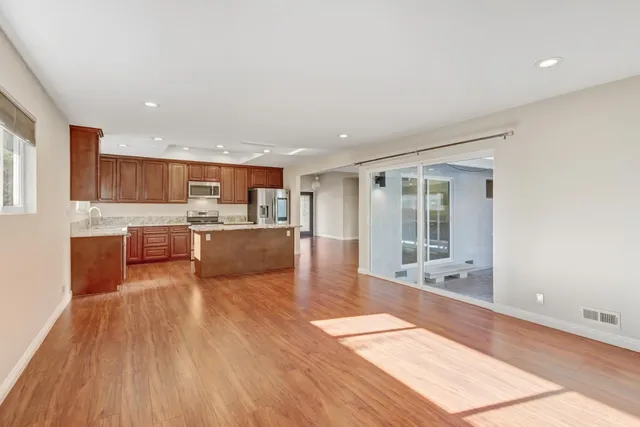 a kitchen with stainless steel appliances granite countertop a refrigerator stove and sink
