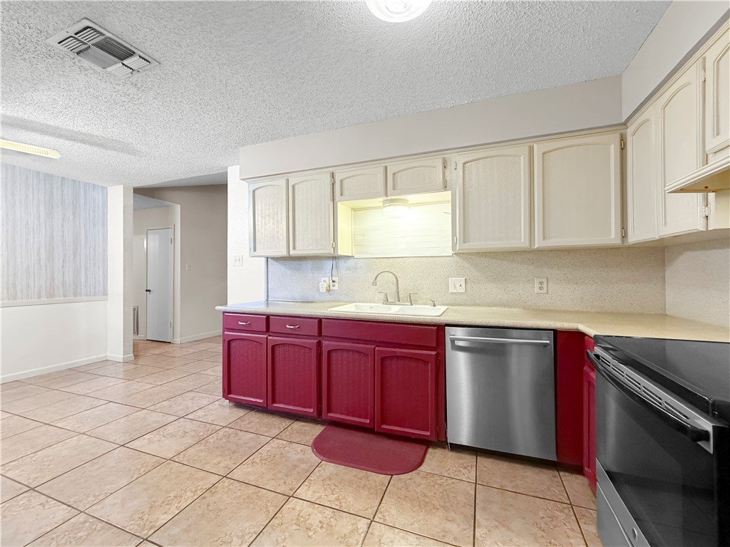 910 Twite Circle Corpus Christi, TX 78418 - Photo 14 of 40 a kitchen with stainless steel appliances granite countertop a sink and a stove