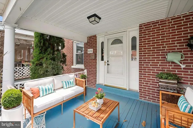 a outdoor living space with furniture and a potted plant