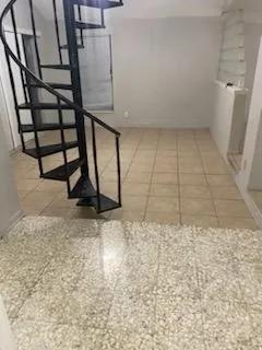a kitchen with a stove top oven and cabinets