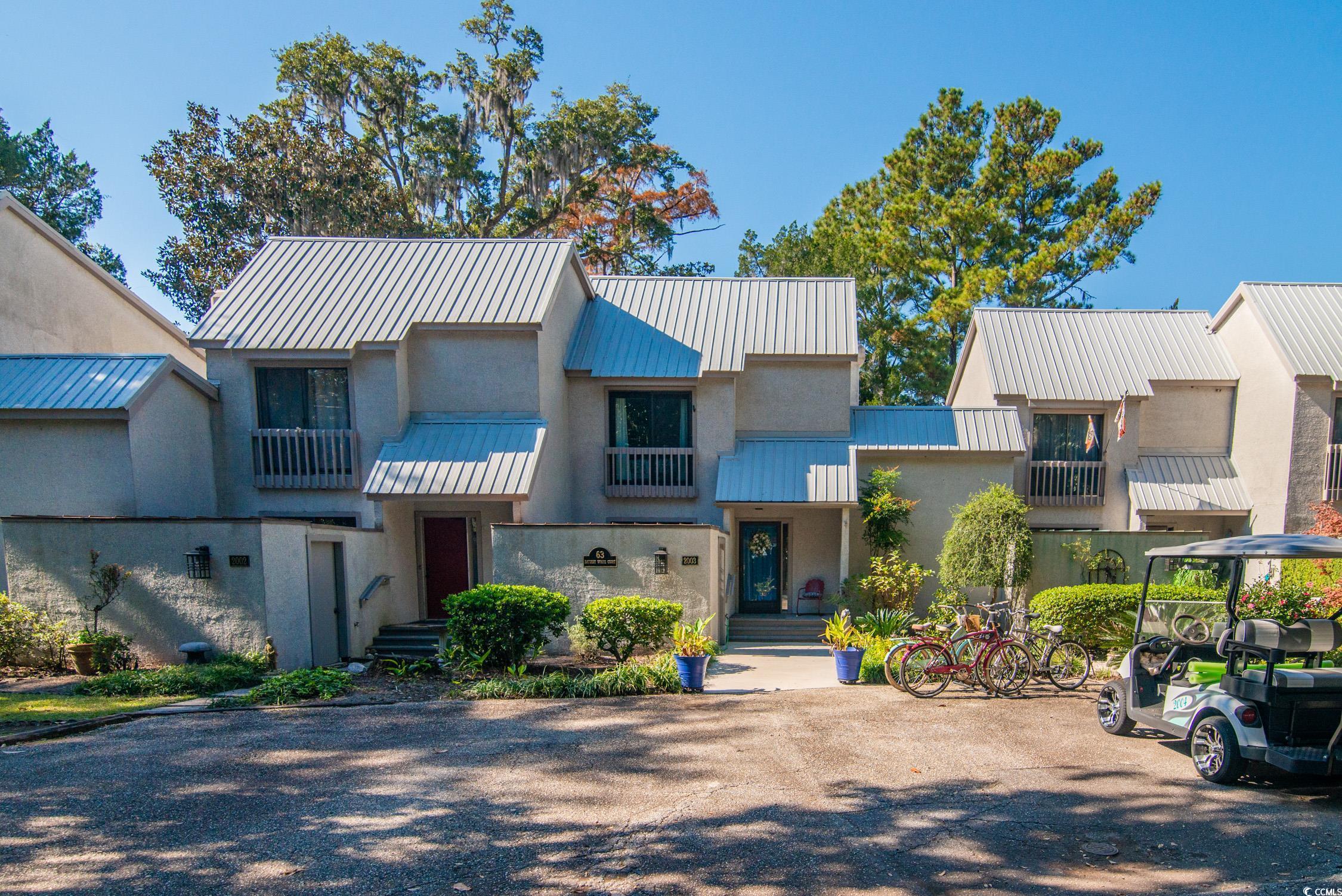 63 Battery White Court, Unit 2C Georgetown, SC 29440 - Photo 1 of 38 View of property with a metal roof, a balcony, and a standing seam roof